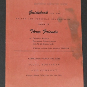 May include: A red cover of a guidebook for health and personal development. The title is "Three Friends" and the book is part of the Curriculum Foundation Series by Scott, Foresman and Company.