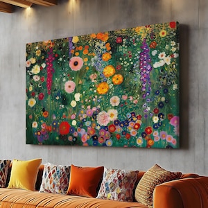 May include: A large floral painting with a vibrant array of colorful flowers, including pink, yellow, and red blooms, hangs above an orange sofa. The room features a modern design with a concrete wall and wooden ceiling beams.