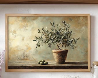May include: A framed rectangular wall art print featuring a potted olive tree with green leaves and small olives. The tree sits in a terracotta pot on a wooden surface against a textured, mottled beige and light brown background with three olives.