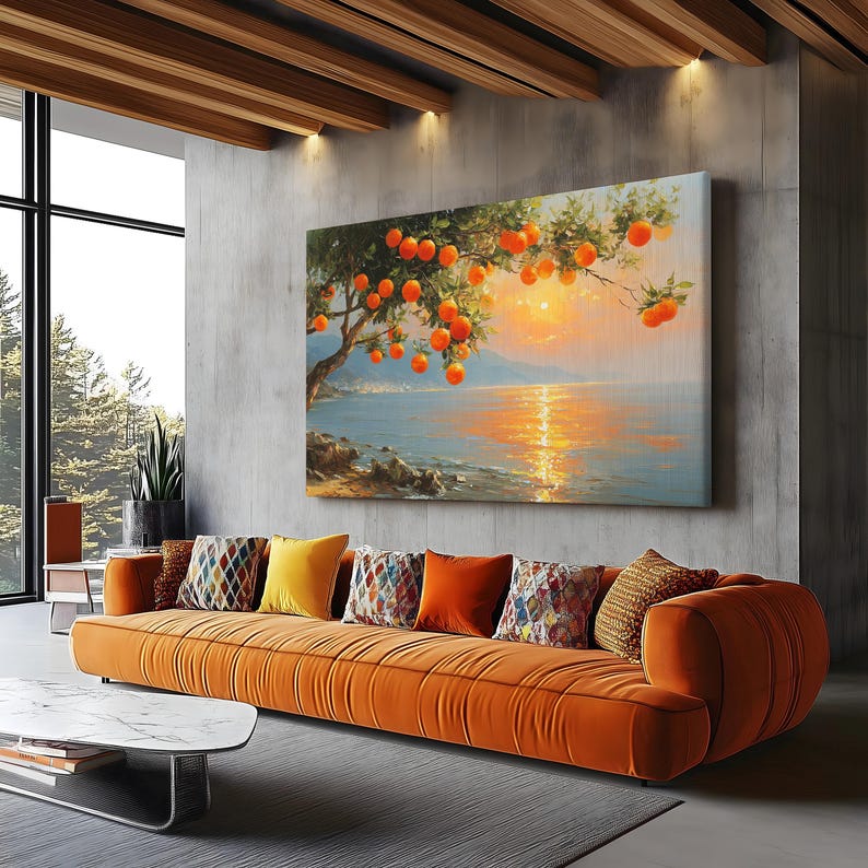 May include: A large canvas art print depicts an orange tree laden with fruit, overlooking a tranquil sea at sunset. The artwork hangs above an orange velvet sofa with decorative pillows, creating a warm and inviting living space.