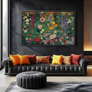 May include: A large framed floral painting with a black frame hangs above a black leather sofa. The painting features a vibrant array of colorful flowers. Several throw pillows in shades of orange, red, and yellow adorn the sofa.