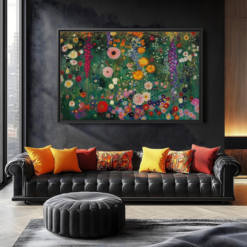 May include: A large framed floral painting with a black frame hangs above a black leather sofa. The painting features a vibrant array of colorful flowers. Several throw pillows in shades of orange, red, and yellow adorn the sofa.