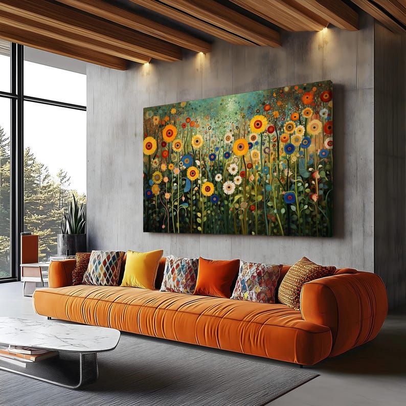 May include: A large canvas print of a colorful floral field with yellow, blue, and red flowers. The print is hanging on a gray wall above a long orange couch with pillows.