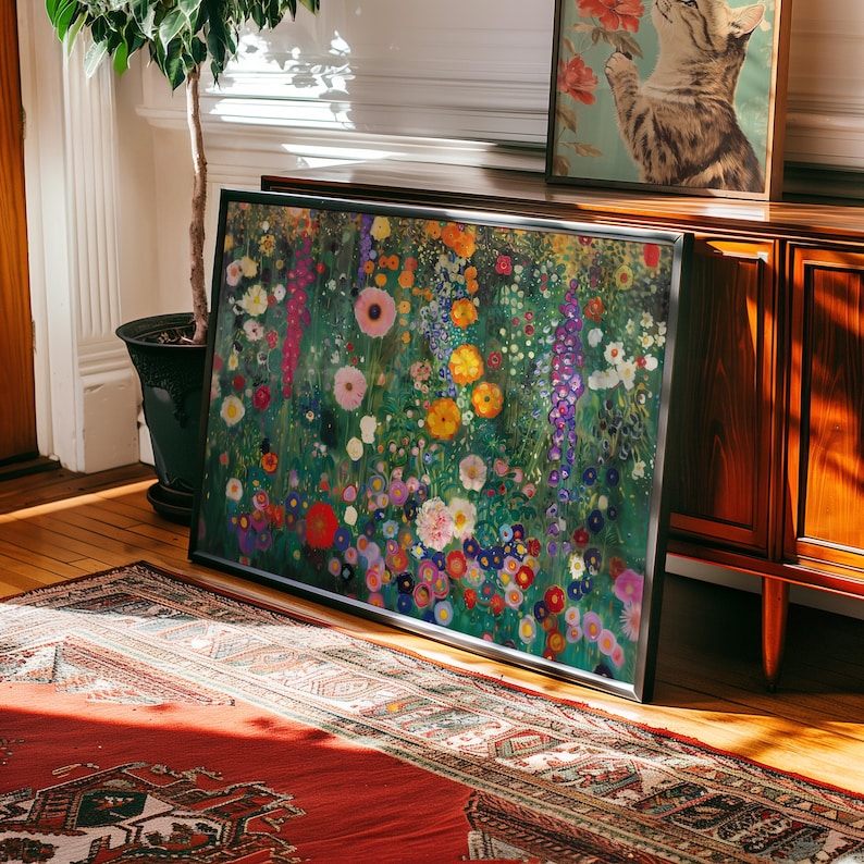 May include: A framed floral art print featuring a vibrant meadow of colorful flowers in shades of pink, yellow, purple, and white. The artwork is displayed on a wooden floor, leaning against a wall, with a potted plant and a vintage cabinet in the background.