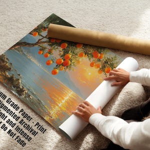 May include: A print on museum-grade paper depicts a landscape with orange fruit trees and a bright sunset. The print is rolled with a brown tube and a white tube. The text on the print says "Museum Grade Paper - Print with Pigmented Archival Inks, Bright and Intense Colors that Do Not Fade."