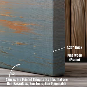 May include: A close-up of a canvas print with a blue and orange abstract design. The canvas is 1.25 inches thick and framed with pine wood. The text on the canvas states that it is printed using non-hazardous, non-toxic, and non-flammable latex inks.