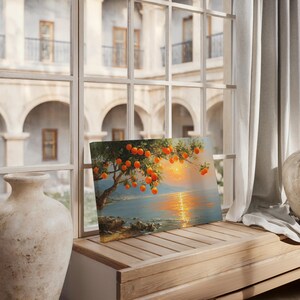 May include: A canvas print of an orange tree laden with ripe fruit, set against a coastal landscape at sunset. The artwork features a vibrant orange and yellow color palette, with a serene ocean and sky.