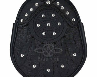 Könnte beinhalten: Schwarze Leder-Sporran mit silberfarbenen Nieten und dekorativem geprägtem Design. Die Sporran hat einen Klappenverschluss und dekorative Quasten. Das Wort "TRADITION" ist unten auf der Sporran zu sehen.