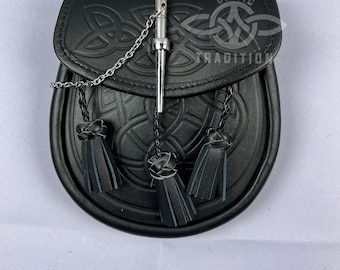 May include: Black leather sporran with embossed Celtic knot design and three black tassels. A silver chain and a metal pin secure the flap. The text "Celtic Tradition" is visible on the flap.