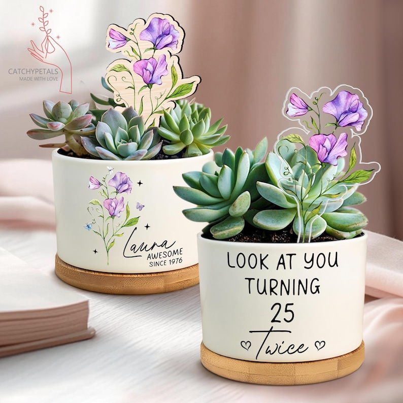 May include: Two white ceramic succulent planters with wooden bases. One planter has the name "Laura" and "AWESOME SINCE 1976" printed on it. The other planter says "LOOK AT YOU TURNING 25 Twice". Each planter has a wooden floral accent.
