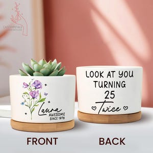 May include: Two white ceramic planters with bamboo saucers. One planter features a floral design with the name "Laura" and the text "AWESOME SINCE 1976." The other planter says "LOOK AT YOU TURNING 25 Twice."