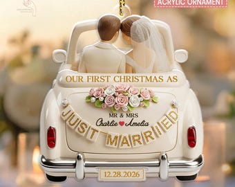 May include: A 2D flat 2-layer acrylic ornament shaped like a cream-colored convertible car with a bride and groom. It features the text "OUR FIRST CHRISTMAS AS", "MR & MRS", "Charlie Amelia", "JUST MARRIED", and "12.28.2026" with pink and white roses.