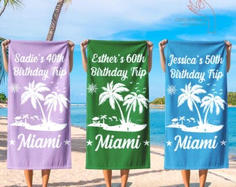 May include: Three beach towels in purple, green, and blue, each with a unique design. The towels feature white palm trees, the word "Miami", and personalized text for a birthday trip. The text includes names and milestone ages.