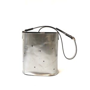 Leather bucket bag silver metallic with punched stars and moon. image 1