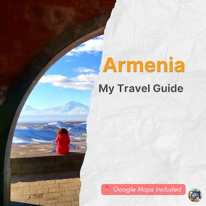 May include: A travel guide cover with the word "Armenia" in orange, and the text "My Travel Guide". The image shows a person in a red jacket looking at a snowy mountain range through an archway.