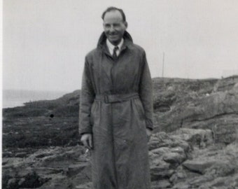 1950's Photo of a Man in a Raincoat & Plus Fours Stood on Rocks