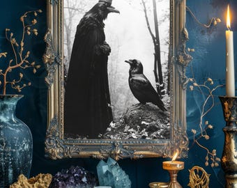 May include: A framed black and white print of two ravens, one wearing a crown, in an ornate gold frame. The image is set against a dark blue wall, with candles, crystals, and tarot cards on a wooden surface.