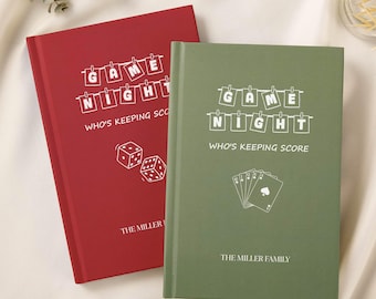 May include: Two hardcover game night journals, one red and one green. The red journal features dice graphics, while the green journal has playing card graphics. Both have the text "GAME NIGHT" and "WHO'S KEEPING SCORE".