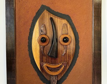 Escultura en relieve de madera de Casimir Zinga – Arte africano gabonés, rostro de madera mixta (60 x 76 cm)