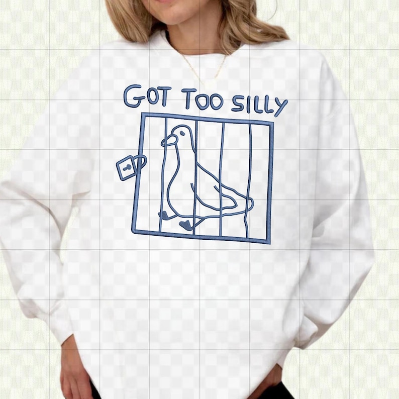 May include: White sweatshirt with a blue graphic of a bird in a cage, with the text "GOT TOO SILLY" above the cage. The design is a simple line drawing style.
