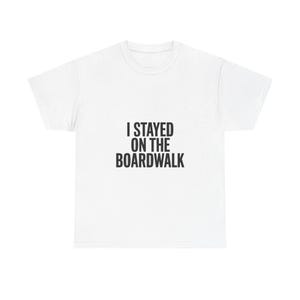 May include: White t-shirt with the text "I STAYED ON THE BOARDWALK" in black, centered on the front. The shirt has a crew neck and short sleeves, made of a soft, likely cotton material. A casual, everyday wear item.