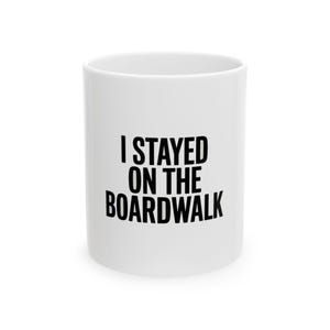 May include: White ceramic mug with the text "I STAYED ON THE BOARDWALK" in bold black letters. The mug is cylindrical and has a simple, clean design, suitable for hot or cold beverages.