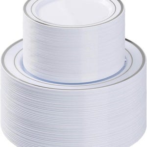 May include: A stack of white disposable plates with a silver rim. The plates are arranged in two stacks, one on top of the other. The plates are made of a lightweight material and are suitable for parties and events.