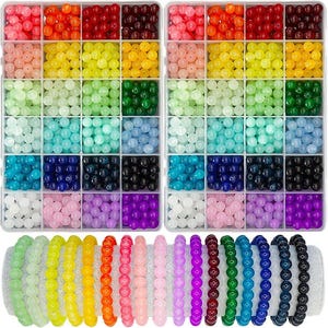 May include: A craft supply set featuring two clear plastic organizers filled with colorful round beads in various shades. Below are several beaded bracelets in matching colors, including green, yellow, orange, pink, purple, and blue.