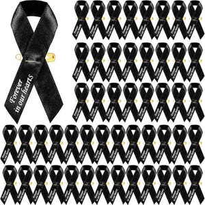 May include: Black satin awareness ribbons with the text "Forever in our hearts" printed in white. Each ribbon is attached to a gold safety pin. A collection of memorial ribbons for remembrance and support.