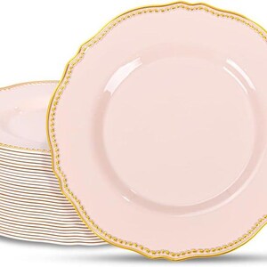 May include: A stack of pink plastic plates with a gold beaded trim. One plate is displayed on top of the stack. The plates have a scalloped edge. The plates are for serving food.