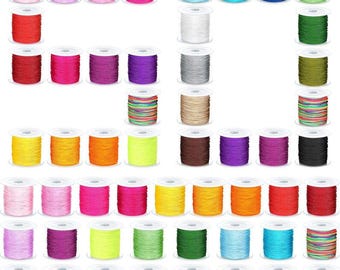 May include: A collection of colorful spools of thread in various shades, including pink, blue, green, yellow, and purple. The spools are arranged in a grid pattern, showcasing a wide range of colors for crafting and sewing projects.