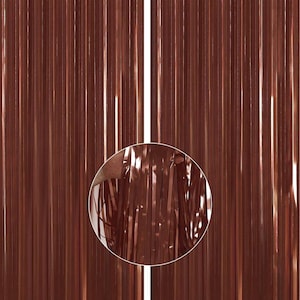May include: A metallic curtain made of thin strips of copper-colored foil. The curtain is made of many vertical strips of foil, creating a shimmering effect.