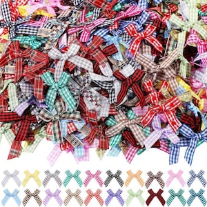 May include: A collection of small, colorful fabric bows in various patterns and colors, including red, green, blue, and plaid. These decorative bows are suitable for crafts and embellishments.