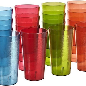 May include: A collection of tall, textured plastic tumblers in various colors: blue, red, green, and orange. The glasses are stacked in groups, showcasing their vibrant hues and simple design, suitable for everyday use.
