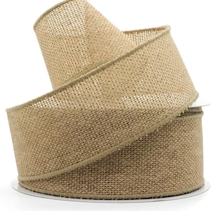 May include: A roll of natural burlap ribbon. The ribbon is a light tan color with a woven texture. The edges are finished with a matching trim. The ribbon is rolled on a white cardboard spool.