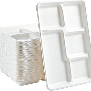 May include: A stack of white, rectangular disposable food trays with five compartments. One tray is separated from the stack, showing the individual compartments. The trays are made of a light-colored, possibly paper-based material.