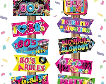 May include: A set of eight colorful 80s themed party signs with arrows pointing in different directions. The signs feature phrases like "Back to the 80s", "I love the 80s", "80s Best Hits", "80s Rules", "Touch My Joystick", "Big Hair Blowout", "Let's Dance", "Party Time!" and "Totally Radical".