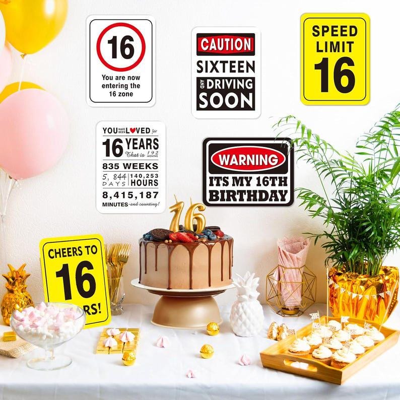 May include: A festive scene with a chocolate cake topped with berries and a gold "16" candle. Signs with text like "Caution Sixteen Driving Soon" and "It's My 16th Birthday" are displayed. Balloons and cupcakes complete the party setting.
