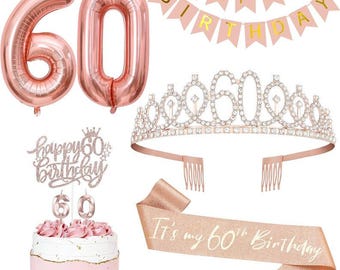 May include: A collection of rose gold birthday decorations, including number 60 balloons, a tiara, a sash that reads "It's my 60th Birthday", and a cake with a topper that says "happy 60th birthday". A banner spells out "Happy Birthday".