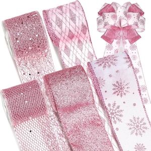 May include: An assortment of pink decorative ribbons, including glitter, mesh, and snowflake patterns. A pre-made bow with snowflake accents is also visible. These ribbons are suitable for gift wrapping and holiday decorations.