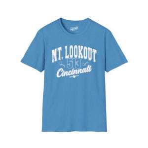 May include: A light blue t-shirt with a white graphic print that says "MT. LOOKOUT 513 Cincinnati" with a small Ohio state outline and "USA" underneath.