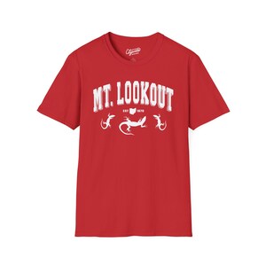 May include: Red short-sleeved t-shirt with white text that reads "MT. LOOKOUT EST. 1970" and three white lizard silhouettes.