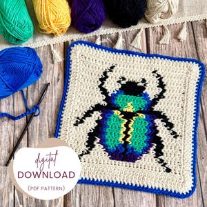 May include: A cream-coloured, square crochet piece with a blue border displays a colourful beetle design in teal, green, yellow, and purple. The text "digital download (PDF pattern)" is shown. Various balls of yarn and a crochet hook are also visible.