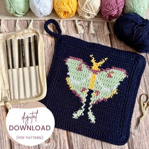 May include: A navy blue crochet potholder with a moth design in shades of green, yellow, and pink. The image also shows a beige pencil case with black pencils, balls of yarn, and the text "DIGITAL DOWNLOAD (PDF PATTERN)".