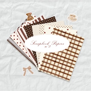 May include: A collection of scrapbook papers in various patterns, including polka dots, stripes, and plaid, in shades of brown and cream. The papers are arranged in a fan shape, with a decorative oval label that reads "Scrapbook Papers n&deg;3". A small teddy bear and a cup of coffee sticker are also present.