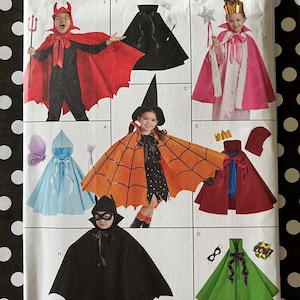 May include: Simplicity pattern 8729 features children's Halloween costume designs. The pattern includes options for a devil, witch, princess, bat, and other characters. The costumes are shown in various colors, including red, black, orange, and green.