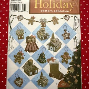 May include: Simplicity Holiday pattern collection featuring various Christmas ornament designs. The cover displays gingerbread houses, gingerbread men, a Christmas tree, and a stocking. The pattern is one size.