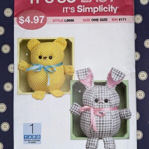 May include: A sewing pattern featuring two stuffed animal designs: a yellow bear with white polka dots and a blue ribbon, and a black and white houndstooth bunny with pink ears and a pink ribbon. The pattern is labeled "IT'S SO EASY" and "IT'S Simplicity".