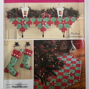 May include: Simplicity sewing pattern 3567 for Christmas decor, featuring a quilted mantel runner, two stockings, and a tree skirt. The items are made from red and green fabric with star motifs and polka dots, designed by Darlene Zimmerman.