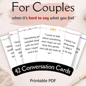 May include: A set of 42 conversation cards for couples, designed to encourage communication. The white cards feature decorative borders and phrases such as "I want to talk about something." The words "For Couples" are displayed at the top.
